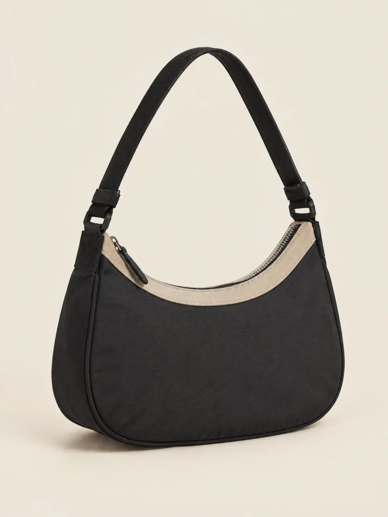 Arc Shoulder Bag front view in Asphalt with Sand curved zip panel