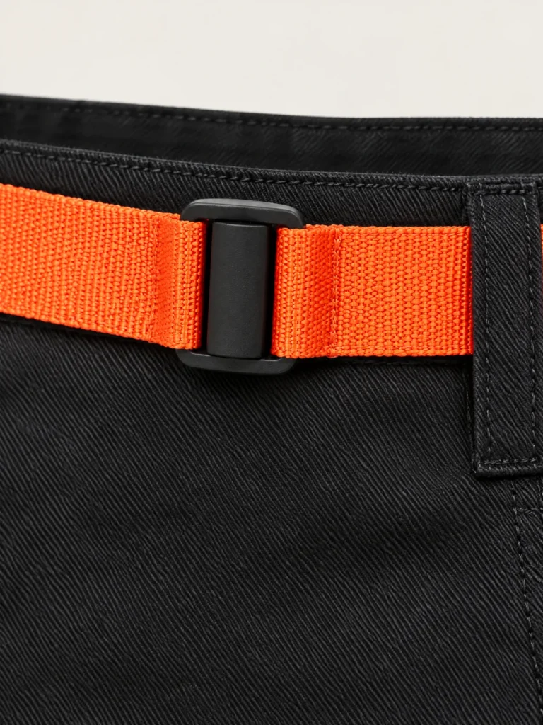 Close-up of Signal orange webbing belt with matte black slider buckle