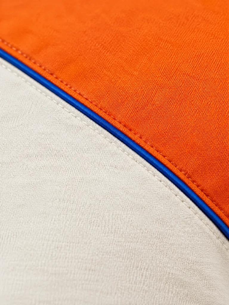 Close-up of diagonal panel seam with thin Lane Blue piping detail