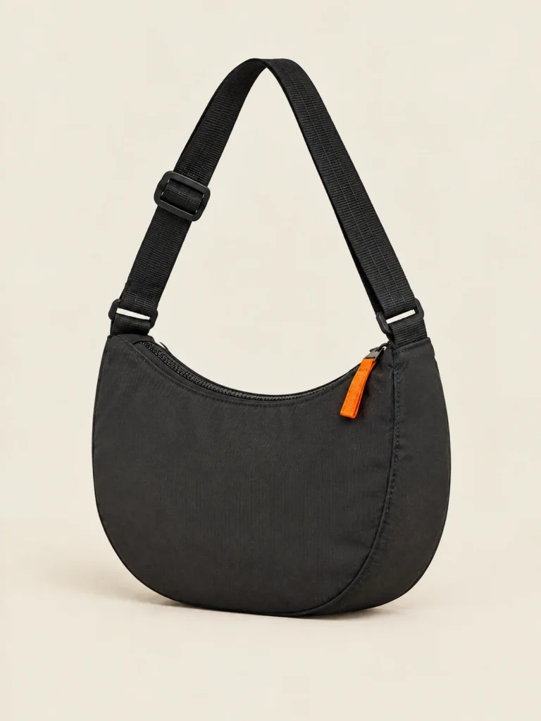 Half-Moon Zip Bag side view showing curved shape and adjustable webbing strap