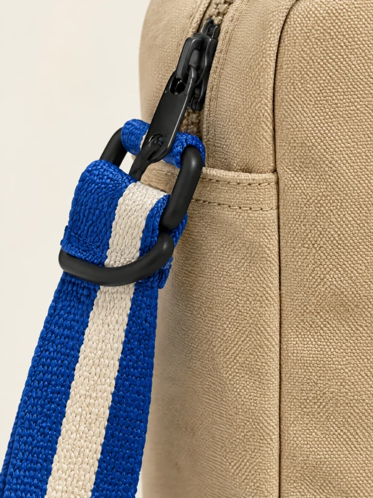 Close-up of Lane Blue and Chalk striped webbing strap with black hardware