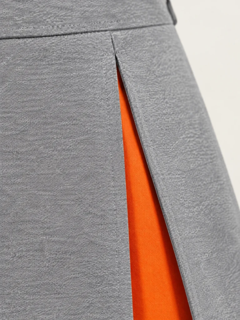 Close-up of knife pleat and Signal orange inset detail