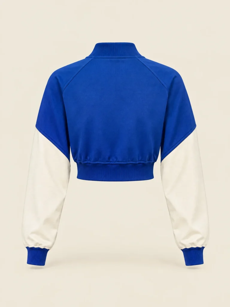 Back view of Lane Blue Relay Crop Track Jacket with rib hem