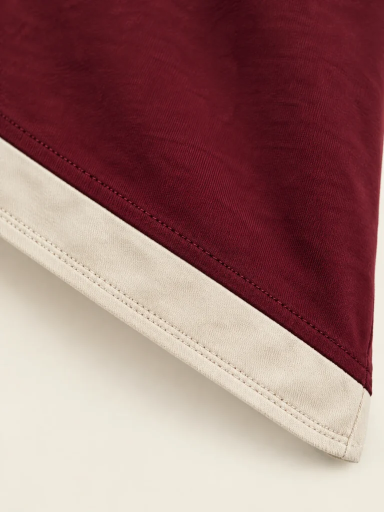 Close-up of Chalk inset panel along diagonal hemline of Sidestep Asymmetric Hem Tee
