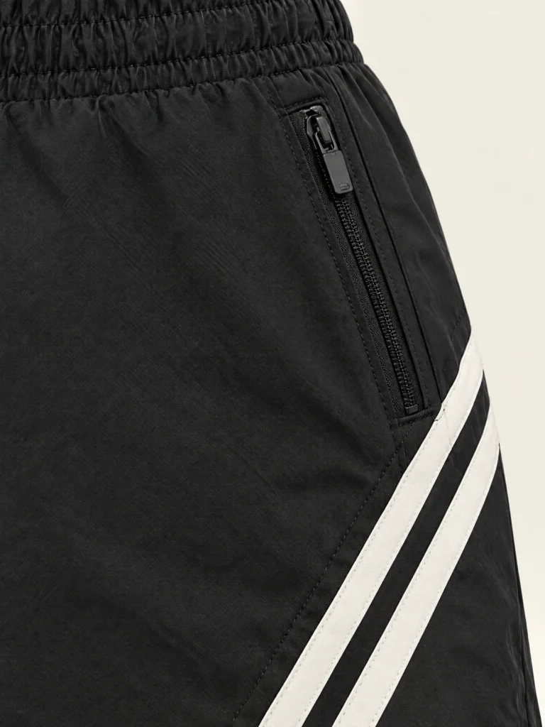 Close-up of angled Chalk stripe and zip pocket detail on Asphalt skirt